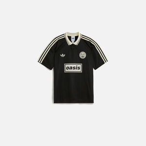 Adidas x Oasis Tour Jacquard Jersey in black with cream stripes, embroidered Oasis and Adidas logos on front.