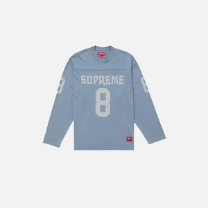 Blue long-sleeve shirt with 'Supreme' branding on a white background