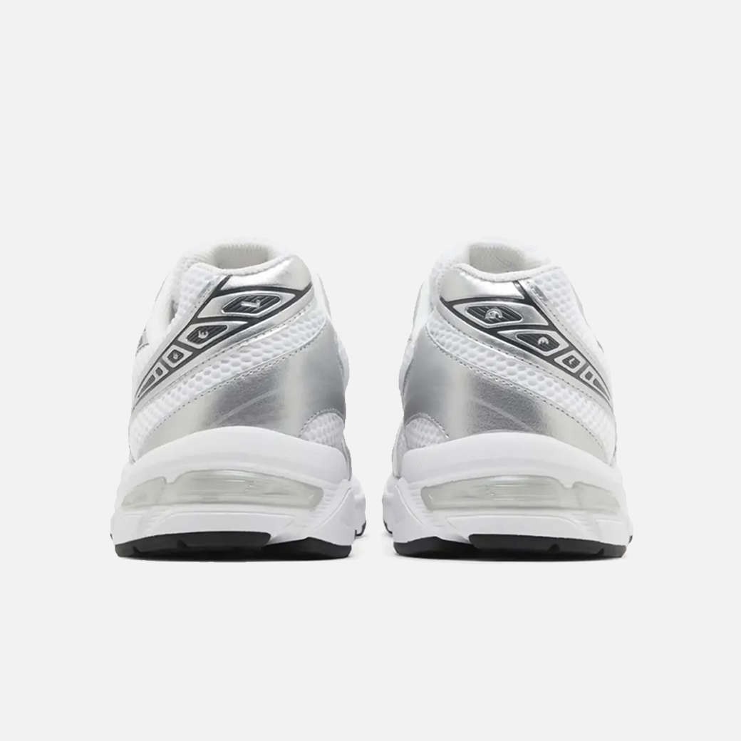 A pair of ASICS Gel-1130 white and silver running shoes with mesh overlays and GEL technology for shock absorption, back view.