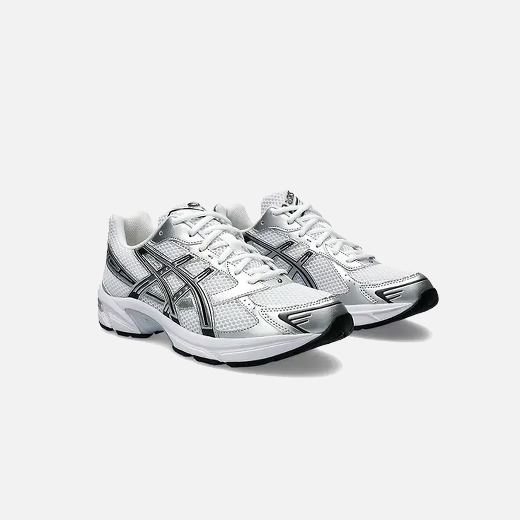 A pair of ASICS Gel-1130 white and silver running shoes with mesh overlays and GEL technology for shock absorption, Side view.