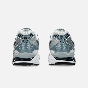ASICS Gel-Kayano 14 Fjord Grey sneaker with a combination of grey, blue, and white colors, showcasing the side profile of the sneaker with mesh material and cushioning technology. Back View.