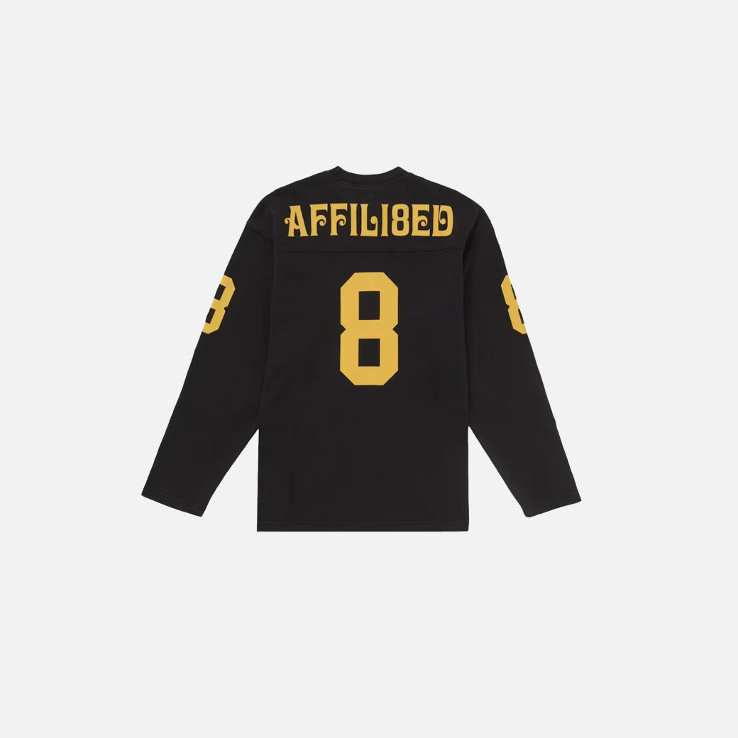 Black long-sleeve shirt with yellow text and numbers on a white background