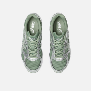 ASICS Gel-1130 running shoe in swamp green, white, olive, and silver colors, with a mesh upper and a flat sole. Top view.