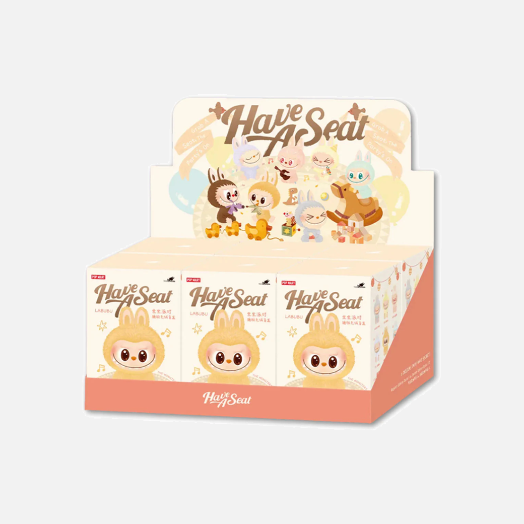 Display box of 'Have A Seat' products with cartoon characters on a light gray background